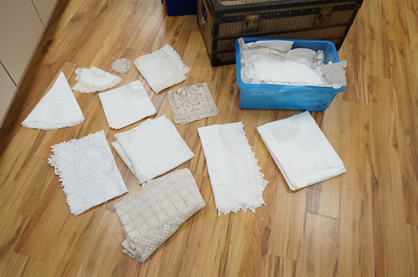 A collection of early 20th century and later crochet, cut work and drawn thread table linens and a large embroidered table cloth
